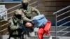 FILE - Bosnian Serb police escort a man suspected of links to Islamic extremists to court in the town of Banja Luka, Bosnia, May 8, 2015.