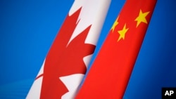 FILE - Flags of Canada and China are placed for the first China-Canada economic and financial strategy dialogue in Beijing, Nov. 12, 2018.