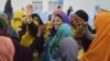 A handout picture released by the African Union-United Nations Information Support Team, shows Yurub Ahmed Raabi, the winner of a seat in the Somalia's parliament (House of the People), celebrating with delegates who voted for heat a polling station in Mogadishu, Somalia, Dec. 6, 2016.