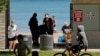 Signs are seen at Clark Street Beach during COVID-19 as people gather in Evanston, Ill., Tuesday, June 23, 2020. Gathering of up to 50 people will be allowed across the state starting Friday as Illinois moves into the fourth phase of its reopening…